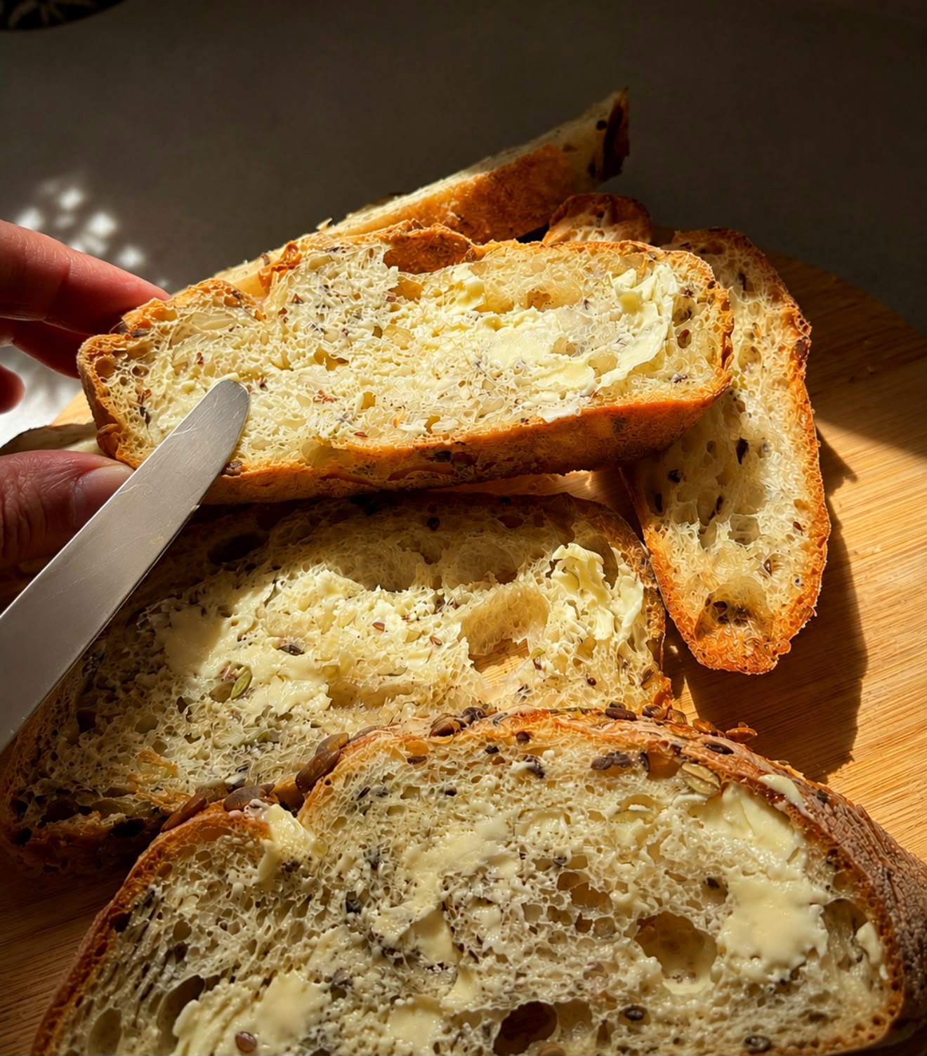 Buttered sourdough slices in warm light
